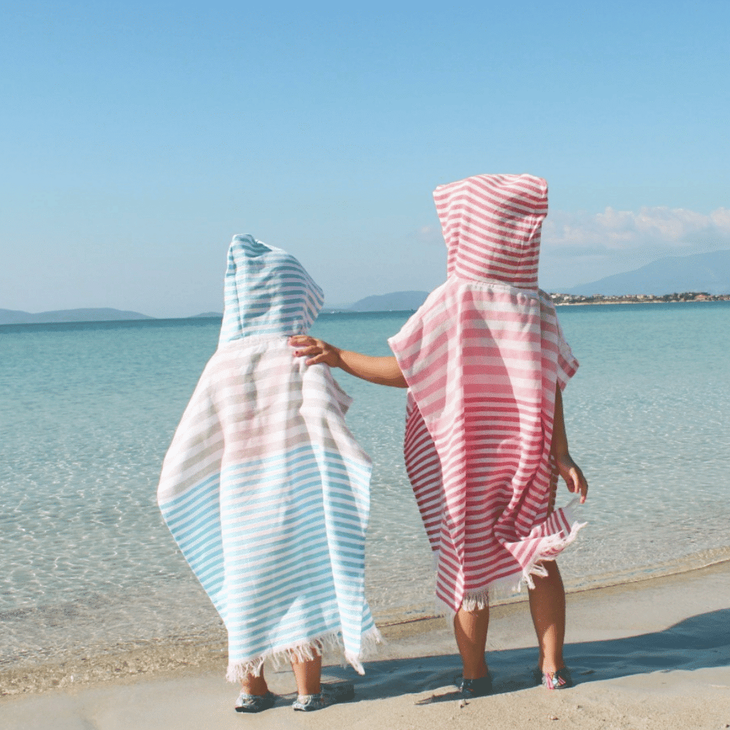 Ipanema Kids Poncho Towel in Mint color, made from 100% cotton, featuring a generous hood and vibrant design, packaged in a recycled gift box.